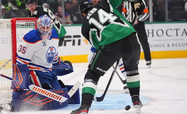 Dallas Stars left wing Jamie Benn (14) scores a goal against Edmonton Oilers goaltender Tristan Jarry (35) during the first period of an NHL hockey game, Thursday, March 12, 2026, in Dallas. (AP Photo/LM Otero)