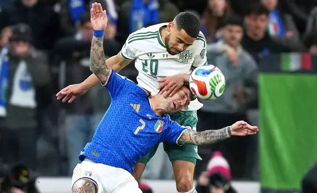 Italy's Matteo Politano, bottom, and Northern Ireland's Brodie Spencer vie for the ball during the World Cup qualifying play-off soccer match between Italy and Northern Ireland, in Bergamo, Italy, Thursday, March 26, 2026. (AP Photo/Antonio Calanni)
