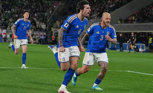 Italy's Federico Dimarco, right, celebrates with teammate Sandro Tonali who scored his side's first goal during the World Cup qualifying play-off soccer match between Italy and Northern Ireland, in Bergamo, Italy, Thursday, March 26, 2026. (AP Photo/Antonio Calanni)