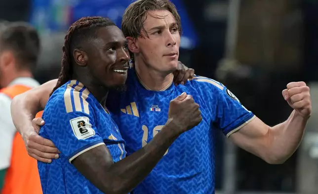 Italy's Moise Kean, left, and teammate Francesco Pio Esposito, right, celebrate after Kean scored his side's second goal during the World Cup qualifying play-off soccer match between Italy and Northern Ireland, in Bergamo, Italy, Thursday, March 26, 2026. (AP Photo/Antonio Calanni)