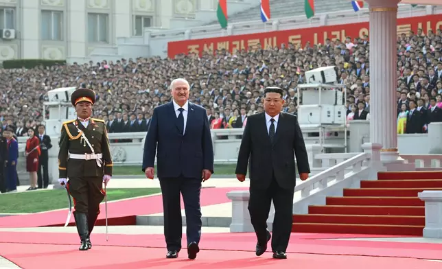 In this photo released by Belarus' Presidential Press Service, North Korea's leader Kim Jong Un, right, and Belarusian President Alexander Lukashenko, center, attend an official meeting ceremony in Pyongyang, North Korea, Wednesday, March 25, 2026. (Belarus' Presidential Press Service via AP)