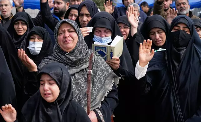 Mourners pray during the funeral of Mehdi Hosseini, a man killed in a U.S.-Israeli strike, at Behesht-e Zahra cemetery in Tehran, Iran, Monday, March 9, 2026. (AP Photo/Vahid Salemi)