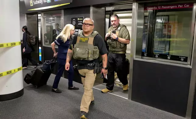 Federal agents step off the inter-terminal subway as they prepare to leave the George Bush Intercontinental Airport and transfer over to Hobby Airport Monday, March 23, 2026, in Houston. (AP Photo/Michael Wyke)
