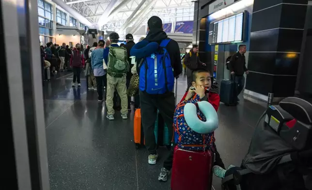 People wait in long TSA security lines at John F. Kennedy International Airport (JFK) in the Queens borough of New York, Monday, March 23, 2026. (AP Photo/Ryan Murphy)