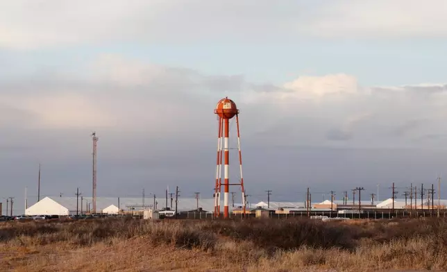 A series of hardened tents at the Camp East Montana immigrant detention center loom large in the desert at a U.S. Army base on the outskirts of El Paso, Texas, Friday, Feb. 13, 2026. (AP Photo/Morgan Lee)