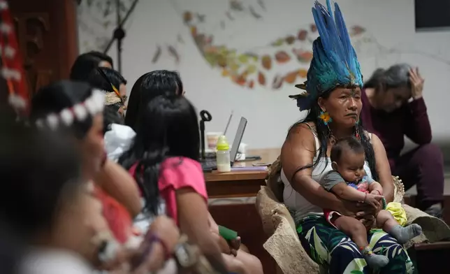 A group of Indigenous women from across Ecuador's Amazon talk after what they call a toxitour where they visited oil fields in Nueva Loja, Ecuador, Friday, March 6, 2026. (AP Photo/Dolores Ochoa)