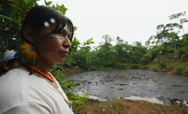 Toa Alvarado, a Kichwa leader, listens as activists explain the environmental damage caused by oil extraction while visiting the contaminated areas in Sucumbios, Ecuador, Friday, March 6, 2026. (AP Photo/Dolores Ochoa)