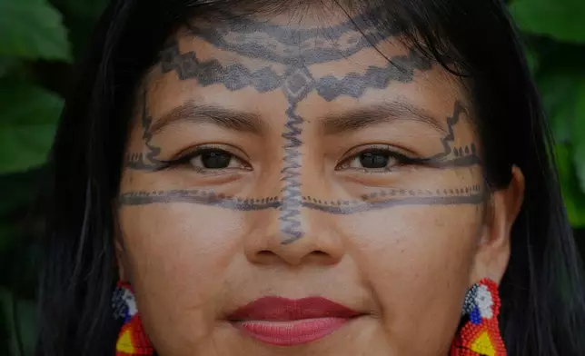 Tamya Dahua, from the Indigenous Kichwa community, poses for a photo in Nueva Loja, Ecuador, Saturday , March 7, 2026. (AP Photo/Dolores Ochoa).