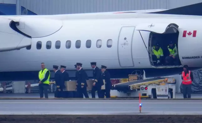 Pilots carry the casket during the repatriation of Jazz Aviation First Officer Mackenzie Gunther, who died after his Air Canada Express plane collided with a fire truck at New York's LaGuardia Airport, in Ottawa, Ontario, Thursday, March 26, 2026. (Sean Kilpatrick/The Canadian Press via AP)
