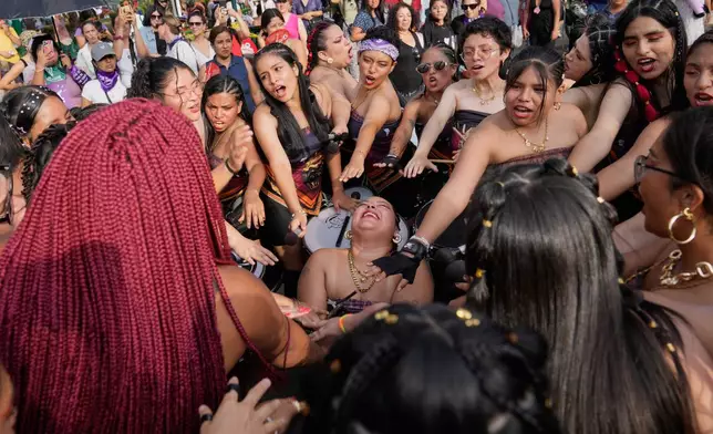 Women perform a good luck ceremony before a march marking International Women's Day, in Lima, Peru, Saturday, March 7, 2026. (AP Photo/Martin Mejia)
