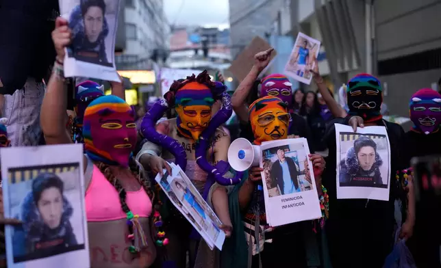 Women hold photos of people who they accuse of being victimizers of women during a march marking the upcoming International Women's Day, in La Paz, Bolivia, Friday, March 6, 2026. (AP Photo/Juan Karita)