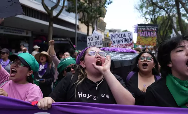 People rally for International Women's Day in Guatemala City, Sunday, March 8, 2026. (AP Photo/Moises Castillo)