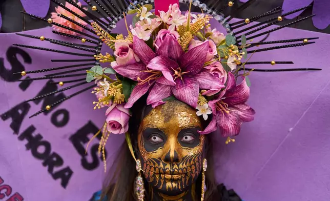 A woman takes part in an International Women's Day protest in Madrid, Spain, Sunday, March 8, 2026. (AP Photo/Manu Fernandez)