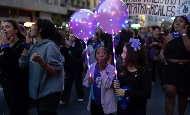 People celebrate International Women's Day in downtown Montevideo, Uruguay, Sunday, March 8, 2026. (AP Photo/Matilde Campodonico)