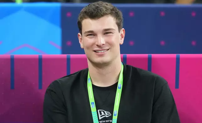 Indiana quarterback Fernando Mendoza (11) watches a drill at the NFL football scouting combine in Indianapolis, Saturday, Feb. 28, 2026. (AP Photo/Julio Cortez)