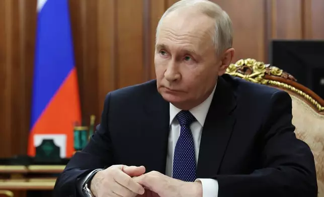 FILE - Russian President Vladimir Putin listens to Roman Artyukhin, the head of the treasury, at the Kremlin in Moscow, on Tuesday, March 3, 2026. (Gavriil Grigorov/Sputnik, Kremlin Pool Photo via AP, File)