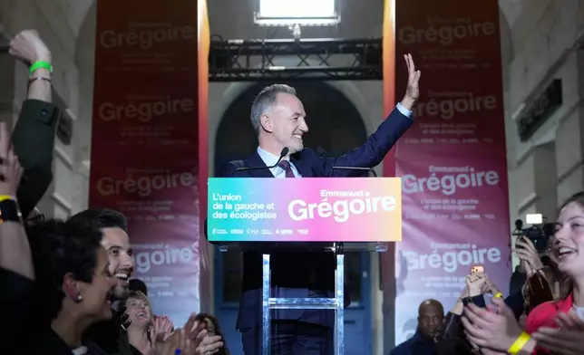 French socialist candidate for Paris mayoral election, Emmanuel Gregoire, center, celebrates after he won the second round of France's municipal elections in Paris, France, Sunday, March 22, 2026. (AP Photo/Thibault Camus)