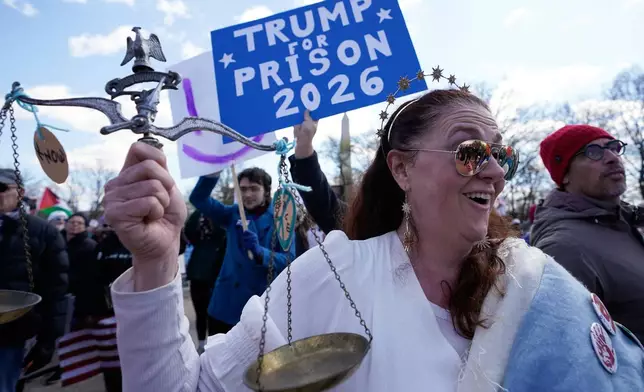 Demonstrators rally near the Washington Monument during the No Kings protest in Washington, Saturday, March 28, 2026. (AP Photo/Jose Luis Magana)