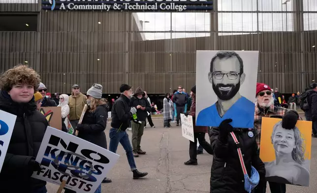 People gather outside Saint Paul College before a "No Kings" protest Saturday, March 28, 2026, in St. Paul, Minn. (AP Photo/Joe Scheller)