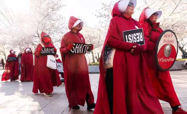 EDS NOTE: OBSCENITY - Demonstrators dressed as characters from the TV series, "The Handmaid's Tale," rally in front of the Martin Luther King, Jr. Memorial during the No Kings protest, Saturday, March 28, 2026, in Washington. (AP Photo/Julia Demaree Nikhinson)