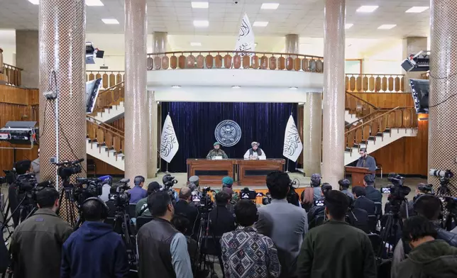 Enayatullah Khowarazmi , left, spokesman of the Defence Ministry, and Hamdullah Fitrat ,deputy spokesman for the Islamic Emirate of Afghanistan speak during a press conference in Kabul, Afghanistan, Tuesday, March 3, 2026.(AP Photo/Siddiqullah Alizai)