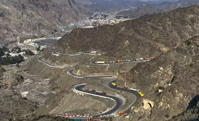 Trucks are parked along roadside following cross-border clashes between Pakistan and Afghan forces, at near Torkham border crossing point, Pakistan, Saturday, Feb. 28, 2026. (AP Photo/Maaz Awan)
