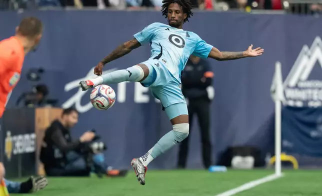 Minnesota United's Kyle Duncan jumps for the ball against the Vancouver Whitecaps during the first half of an MLS soccer match in Vancouver, British Columbia, Sunday, March 15, 2026. (Ethan Cairns/The Canadian Press via AP)