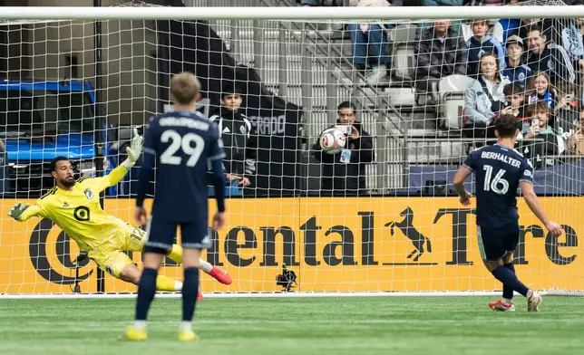 Vancouver Whitecaps' Sebastian Berhalter (16) scores on Minnesota United goalkeeper Drake Callender as Vancouver's Mihail Gherasimencov (29) watches during the first half of an MLS soccer match in Vancouver, British Columbia, Sunday, March 15, 2026. (Ethan Cairns/The Canadian Press via AP)