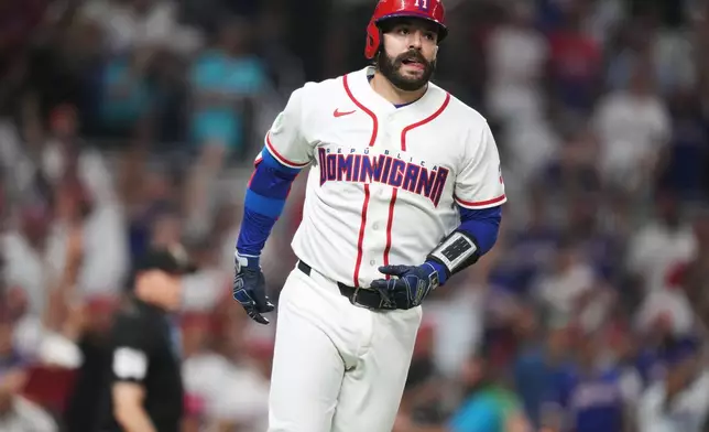 Dominican Republic's Austin Wells runs the bases after hitting a three-run home run to end the game early in the seventh inning of a World Baseball Classic quarterfinal game against South Korea, Friday, March 13, 2026, in Miami. (AP Photo/Lynne Sladky)