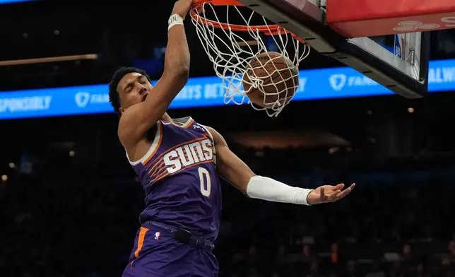 Phoenix Suns forward Ryan Dunn dunks against the Toronto Raptors during the first half of an NBA basketball game, Sunday, March 23, 2026, in Phoenix. (AP Photo/Rick Scuteri)