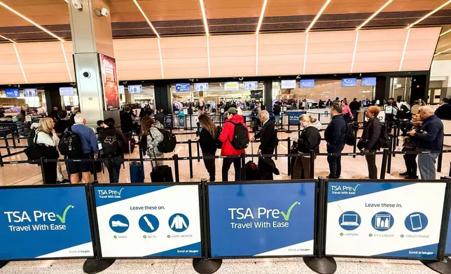 People wait in a TSA security line at Terminal A of Newark Liberty International Airport (EWR) in Newark, N.J., U.S., Tuesday, March 24, 2026. (AP Photo/Eduardo Munoz Alvarez)