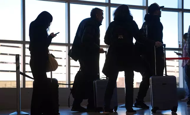 Travelers wait in a security check point line at Philadelphia International Airport, Tuesday, March 24, 2026, in Philadelphia. (AP Photo/Matt Rourke)