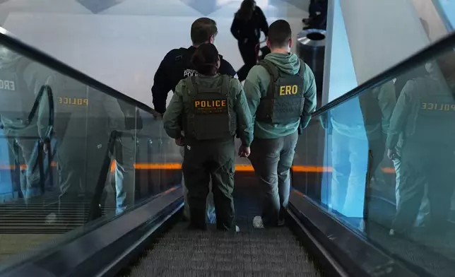 Federal law enforcement officers move through Philadelphia International Airport, Tuesday, March 24, 2026, in Philadelphia. (AP Photo/Matt Rourke)