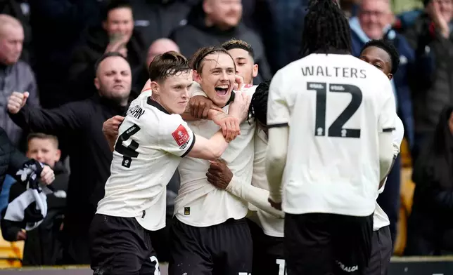 Port Vale's Ben Waine celebrates with teammates after scoring his side's first goal of the game, during the FA Cup fifth round soccer match between Sunderland and Port Vale, in Stoke on Trent, England, Sunday March 8, 2026. (Nick Potts/PA via AP)