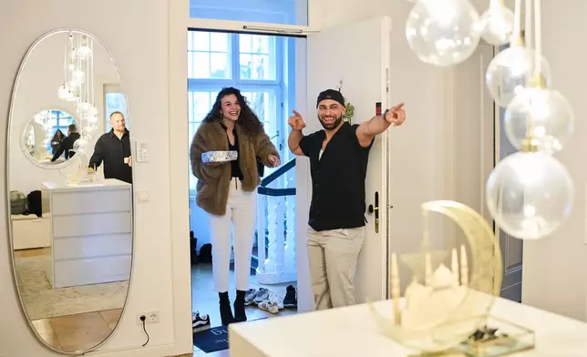 Gay Muslim influencer Ali Darwich, right, welcomes friends for an inclusive Iftar, the Ramadan fast-breaking meal, with friends who are Muslim, Christian, queer and straight, in Berlin, Germany, Wednesday, March 11, 2026. (AP Photo/Ebrahim Noroozi)