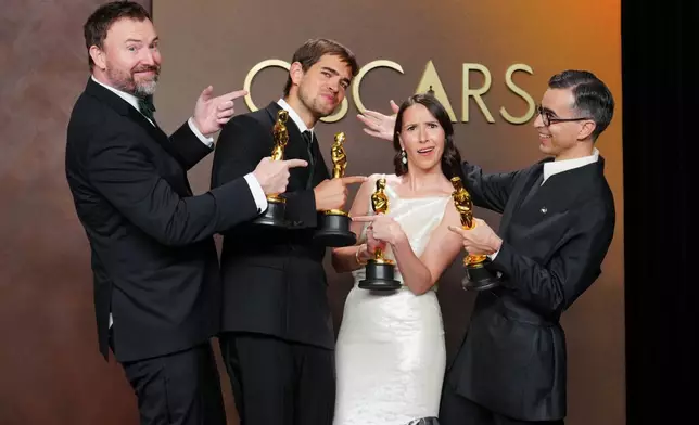 Jack Piatt, far left, and Sam A. Davis, center left, winners of the award for live action short film for "The Singers," and Natalie Musteata, center right, and Alexandre Singh, far right, winners of the award for live action short film for "Two People Exchanging Saliva," pose in the press room after tying in the category for live action short film at the Oscars on Sunday, March 15, 2026, at the Dolby Theatre in Los Angeles. (Photo by Jordan Strauss/Invision/AP)
