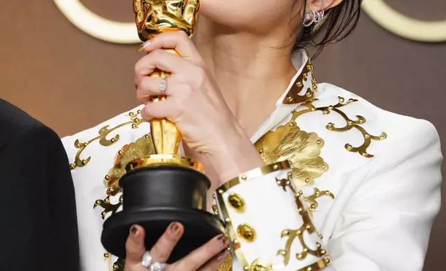 EJAE, winner of the award for music (original song) for "Golden" from "K-pop Demon Hunters," poses in the press room at the Oscars on Sunday, March 15, 2026, at the Dolby Theatre in Los Angeles. (Photo by Jordan Strauss/Invision/AP)