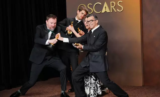 Jack Piatt, far left, and Sam A. Davis, center left, winners of the award for live action short film for "The Singers," and Natalie Musteata, center right, and Alexandre Singh, far right, winners of the award for live action short film for "Two People Exchanging Saliva," pose in the press room after tying in the category for live action short film at the Oscars on Sunday, March 15, 2026, at the Dolby Theatre in Los Angeles. (Photo by Jordan Strauss/Invision/AP)