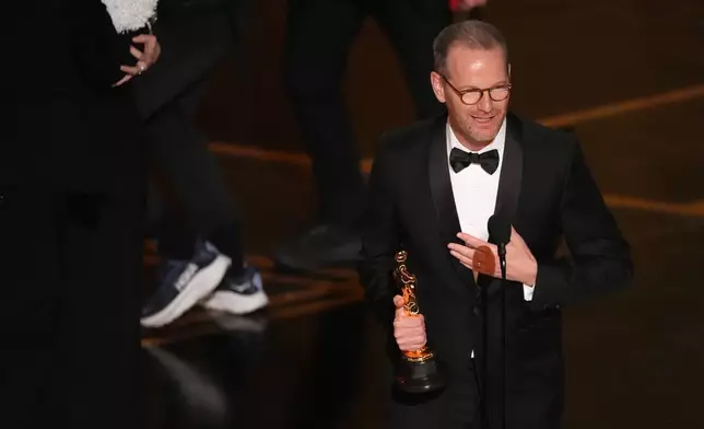 Joachim Trier accepts the award for international feature film for "Sentimental Value" during the Oscars on Sunday, March 15, 2026, at the Dolby Theatre in Los Angeles. (AP Photo/Chris Pizzello)