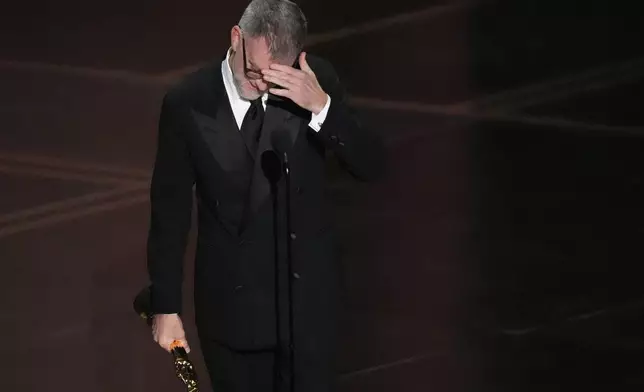 Paul Thomas Anderson accepts the award for directing for "One Battle After Another" during the Oscars on Sunday, March 15, 2026, at the Dolby Theatre in Los Angeles. (AP Photo/Chris Pizzello)