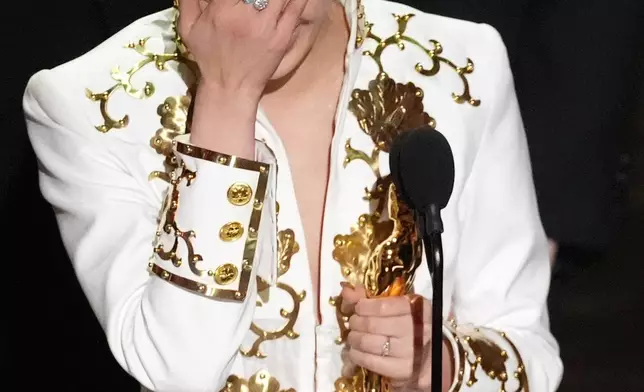 EJAE accepts the award for best original song for "Golden" from "K-pop Demon Hunters" during the Oscars on Sunday, March 15, 2026, at the Dolby Theatre in Los Angeles. (AP Photo/Chris Pizzello)