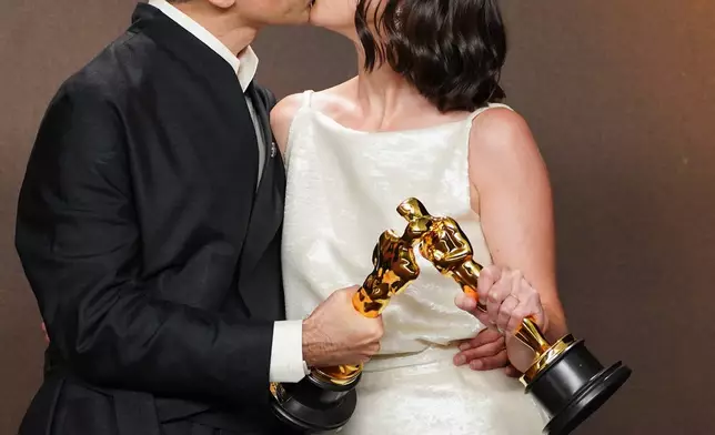 Alexandre Singh, left, and Natalie Musteata, winners of the award for live action short film for "Two People Exchanging Saliva," pose in the press room at the Oscars on Sunday, March 15, 2026, at the Dolby Theatre in Los Angeles. (Photo by Jordan Strauss/Invision/AP)