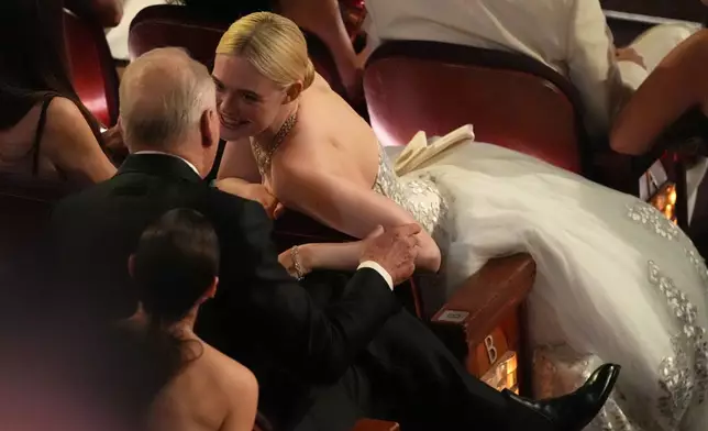 Stellan Skarsgård, left, and Elle Fanning in the audience during the Oscars on Sunday, March 15, 2026, at the Dolby Theatre in Los Angeles. (AP Photo/Chris Pizzello)