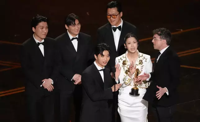 Joong Gyu Kwak, from left, Yu Han Lee, Hee Dong Nam, EJAE, center, Jeong Hoon Seo, Mark Sonnenblick accept the award for best original song for 'Golden' from "K-Pop Demon Hunters" during the Oscars on Sunday, March 15, 2026, at the Dolby Theatre in Los Angeles. (AP Photo/Chris Pizzello)