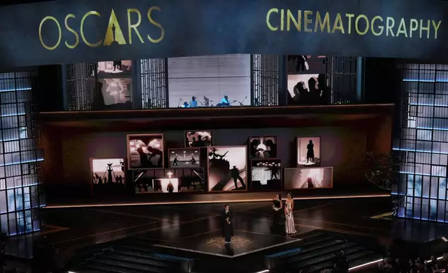 Autumn Durald Arkapaw accepts the award for cinematography for "Sinners" during the Oscars on Sunday, March 15, 2026, at the Dolby Theatre in Los Angeles. Demi Moore looks on from right. (AP Photo/Chris Pizzello)