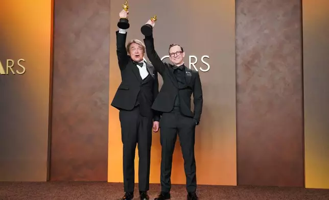 Maciek Szczerbowski, left, and Chris Lavis, winners of the award for best animated short film for "The Girl Who Cried Pearls," pose in the press room at the Oscars on Sunday, March 15, 2026, at the Dolby Theatre in Los Angeles. (Photo by Jordan Strauss/Invision/AP)