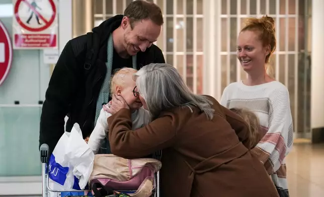 Passengers arrive at Stansted Airport in Stansted, England, Friday, March 6, 2026 on a Government-chartered plane from Muscat, Oman. (AP Photo/Alberto Pezzali)