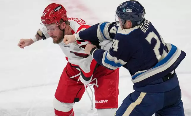 Columbus Blue Jackets' Mathieu Olivier (24) lands a punch on Carolina Hurricanes' Nicolas Deslauriers, left, in the second period of an NHL hockey game in Columbus, Tuesday, March 17, 2026. (AP Photo/Sue Ogrocki)