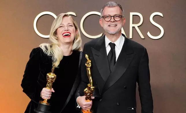Sara Murphy, left, winner of the award for best picture for "One Battle After Another," and Paul Thomas Anderson, winner of the awards for writing (adapted screenplay), directing, and best picture for "One Battle After Another," pose in the press room at the Oscars on Sunday, March 15, 2026, at the Dolby Theatre in Los Angeles. (Photo by Jordan Strauss/Invision/AP)