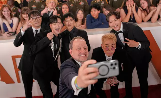 Neckwav, from background left, Kevin Woo, Andrew Choi, Danny Chung, and SamUIL Lee pose for a photograph as they arrive at the Oscars on Sunday, March 15, 2026, at the Dolby Theatre in Los Angeles. (AP Photo/John Locher)